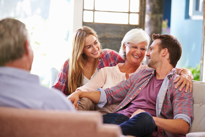 Older couple talking to adult children about senior living