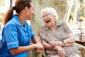 Caregiver with senior woman in memory care