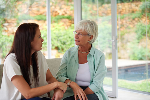 Older woman discussing senior living options with her daughter