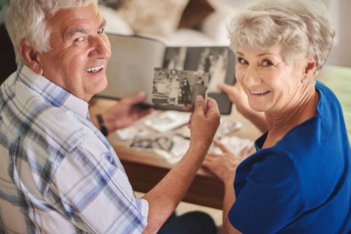 Couple exploring old photos in a memory care community