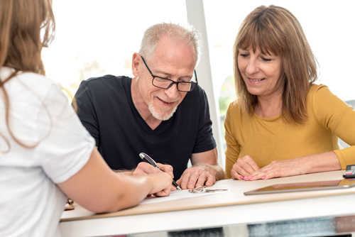 Couple signing estate planning documents