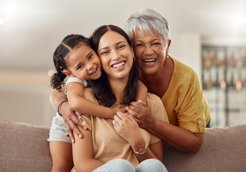 Older woman embracing family members