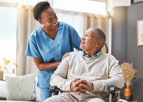 Caregiver with senior man in wheelchair