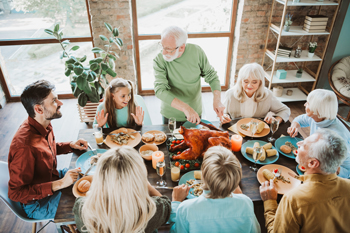 Older couple entertaining family in their home