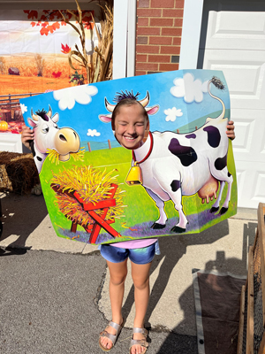 A child with a cow and manger cutout