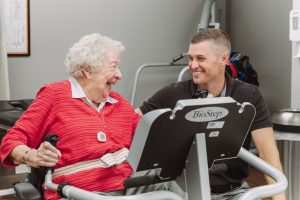 Resident receives help exercising at Friendship Village of Dublin