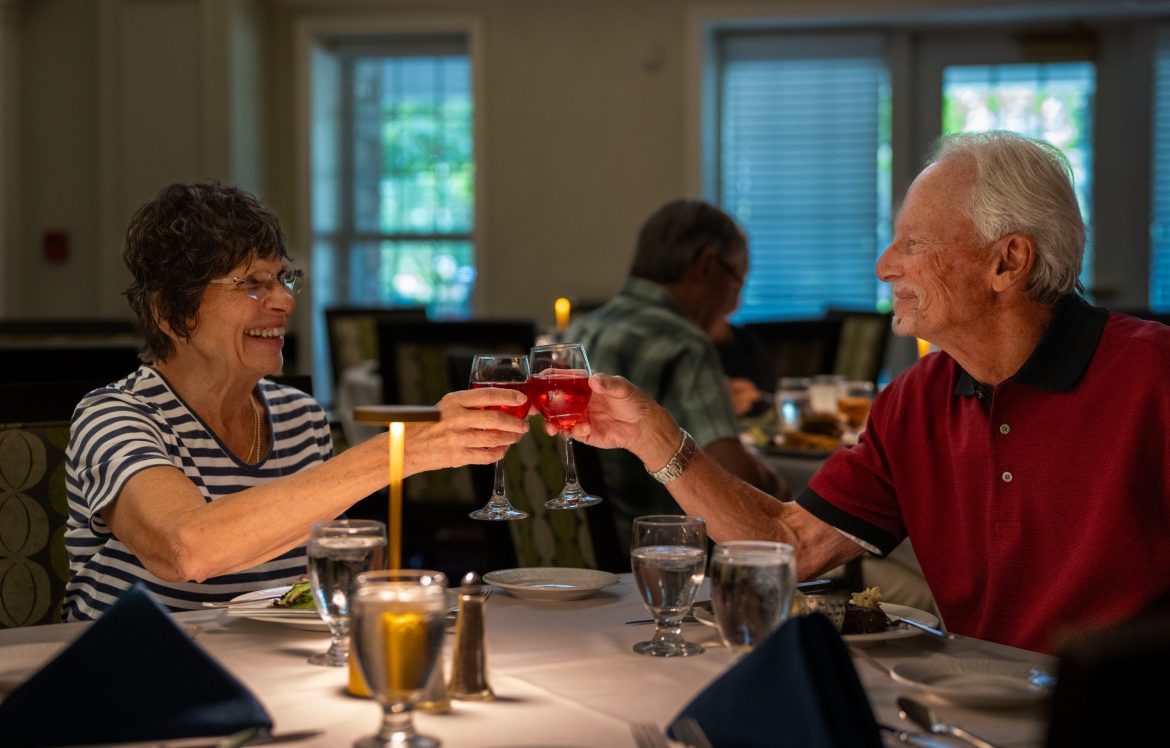 Residents toast with wine glasses