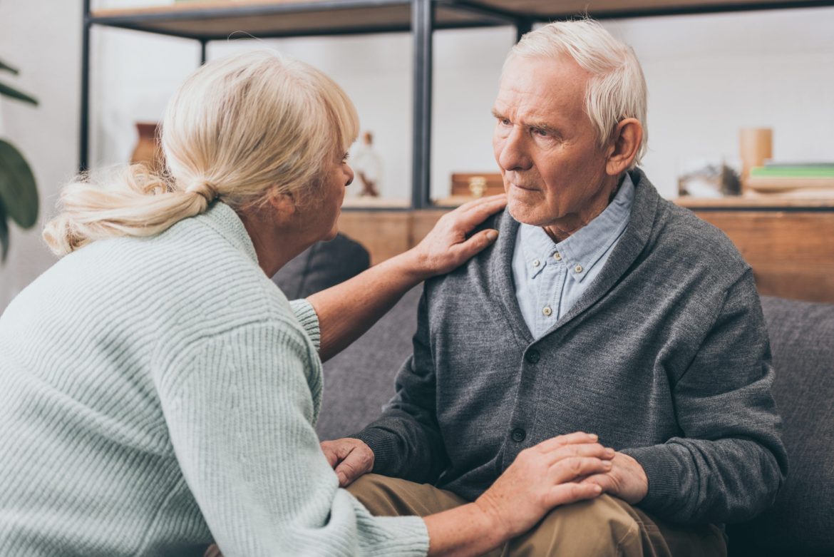 Daughter making eye contact with a man living with dementia.