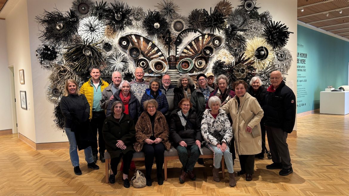 A group of Friendship Village of Dublin Residents in front of an exhibit at the Riffe Gallery.