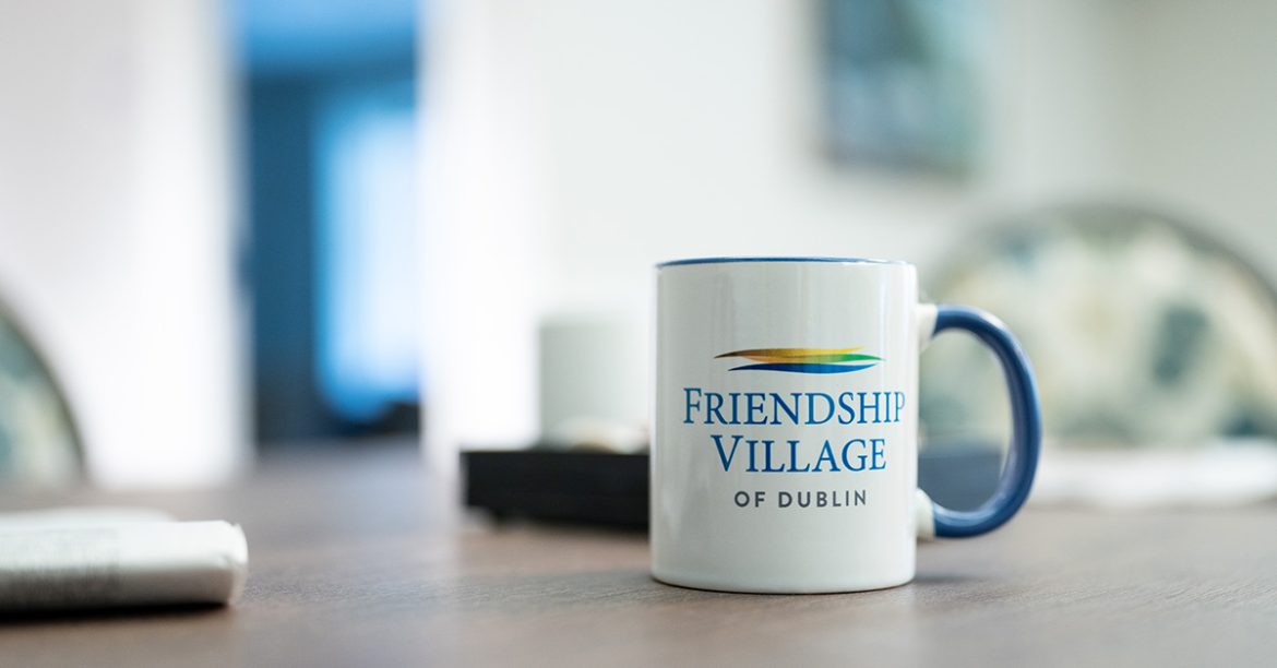 A Friendship Village of Dublin mug on a desk in Alderwood Health and Rehab.