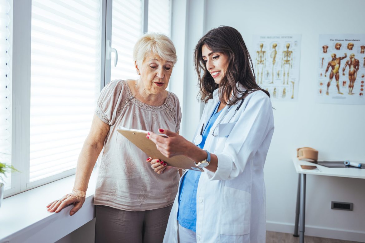 Older woman talking to doctor.