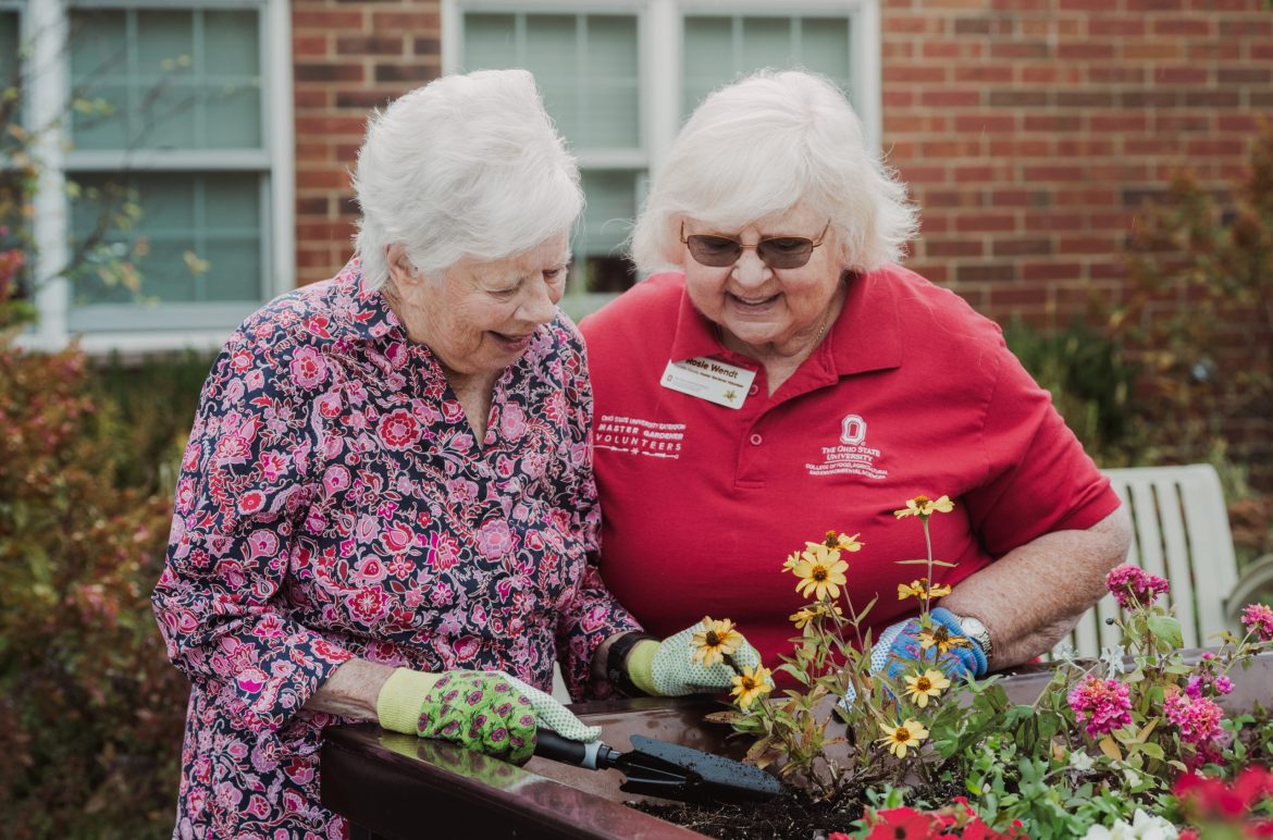 A gardening volunteer works with a Resident in Waterford Place Assisted Living at Friendship Village of Dublin.