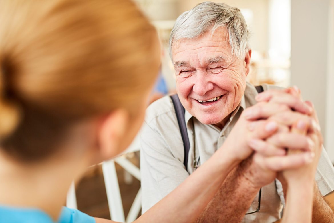 Staff member interacting with man in memory care.