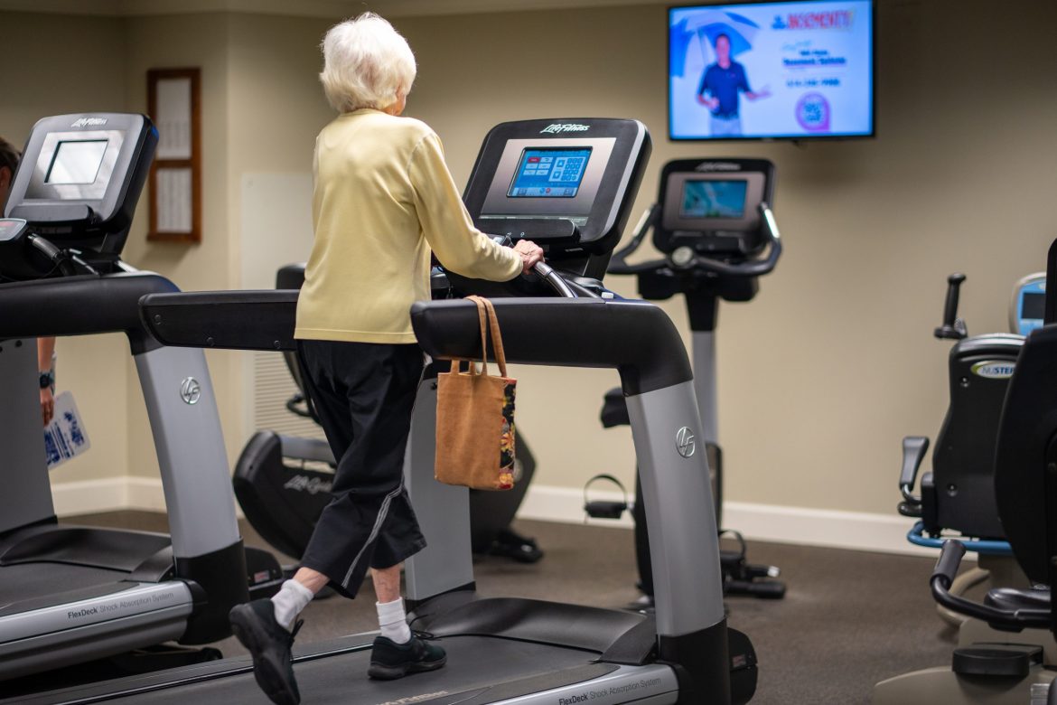 A Resident uses a treadmill while watching television at one of the fitness centers at Friendship Village of Dublin.