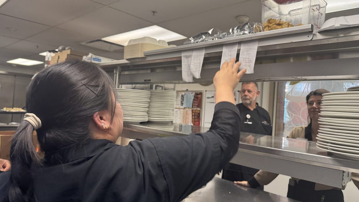 A culinary team member at Friendship Village of Dublin reviews the incoming orders.