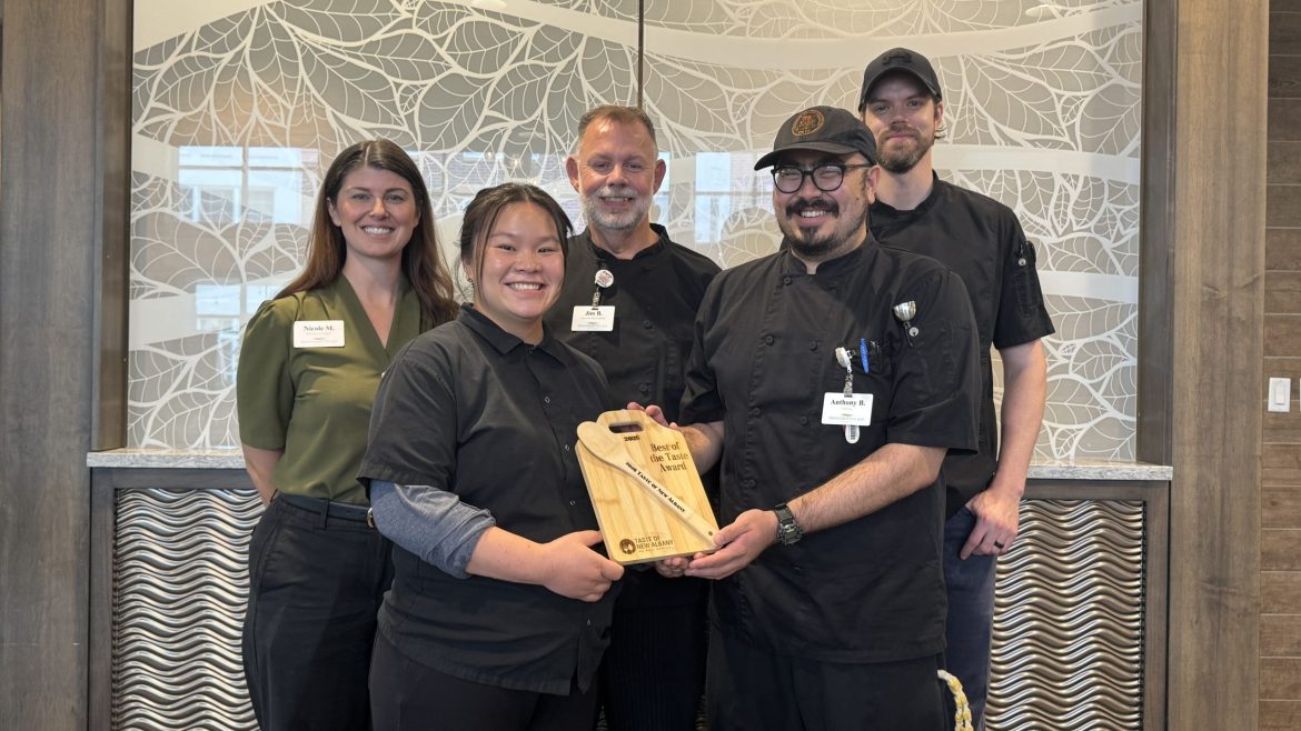 The Friendship Village of Dublin Culinary staff pose with their trophy, a cutting board with a wooden spoon, in the Legacy Dining Room. Pictured (L-R) is Nicole Merando, Katelyn Johnson, Jim Bline, Anthony Bucceri, and Logan Rasnick.