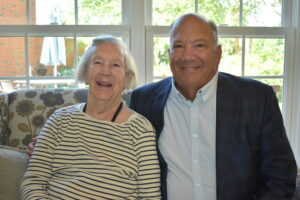 Louise (left) and Jim B. (right) are seated in the Waterford Cafe lobby.